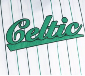 Green cursive embroidered 'Beta' on white pinstriped fabric.