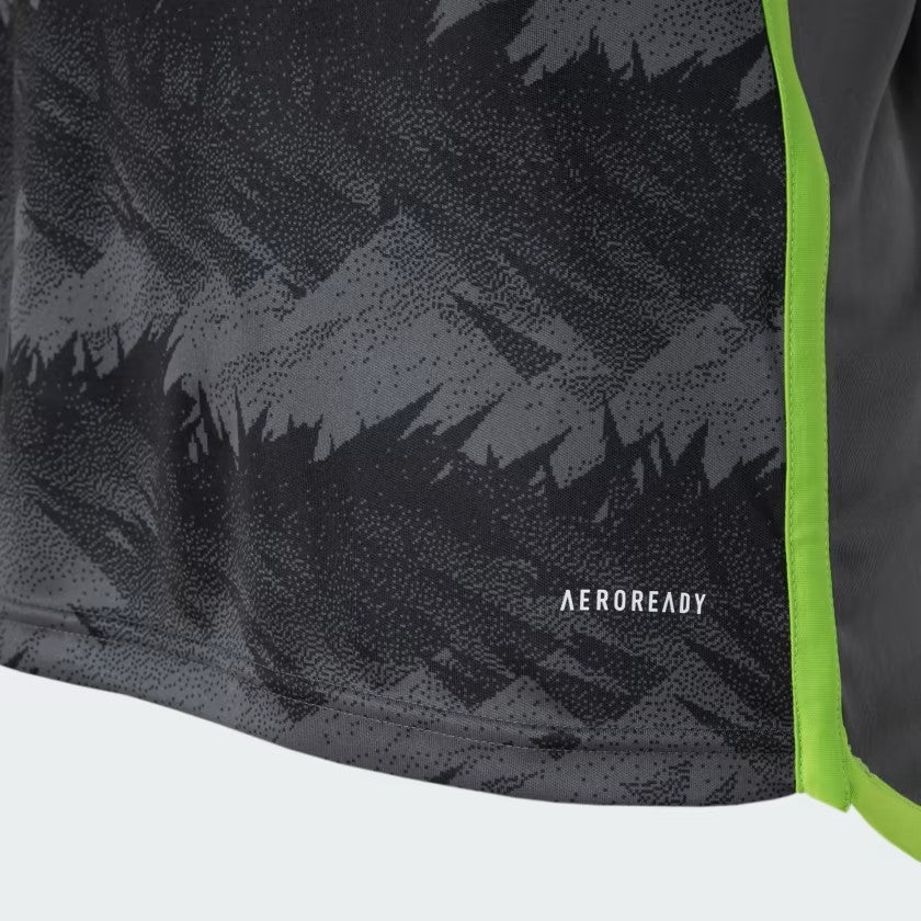 7iG8ekAsKqiQfaW_7a5b86b6-6f8f-4c01-8ff9-fd10f9c88fc1 | UAE SPORT STORE Close-up of dark, textured athletic fabric with a neon lime-green trim and 'AEROREADY' branding.