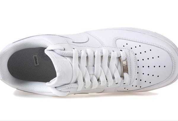 Top view of a white athletic sneaker with laces and a perforated toe box.