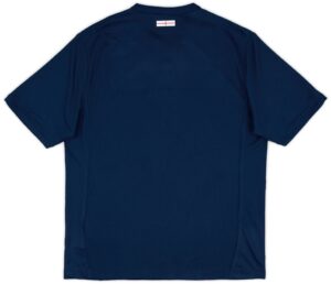 Back view of a navy blue polo shirt with a small white label featuring a red line near the collar area