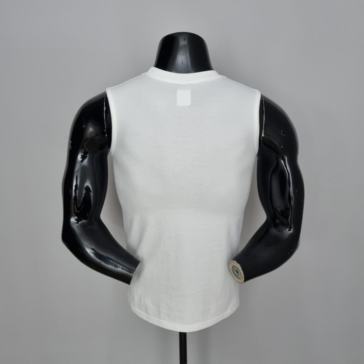 Back view of a white sleeveless shirt on a black mannequin bust against a gray background.