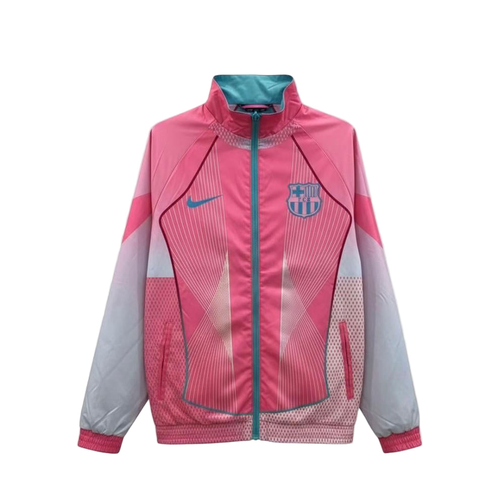 8288e21d-318c-4975-8d9e-7d3bdff3d2f7 Pink FC Barcelona windbreaker with teal zipper and crest on the chest, featuring geometric design elements.