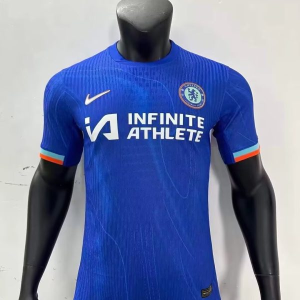 Blue Chelsea football jersey on a mannequin, sponsor logo 'INFINITE ATHLETE' and Nike swoosh visible.