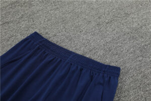 845430bf_1024x1024_2x_92ba347c-95ea-45fc-a253-24e780085f43 | UAE SPORT STORE Blue elastic-waist shorts laid flat on a gray carpeted surface