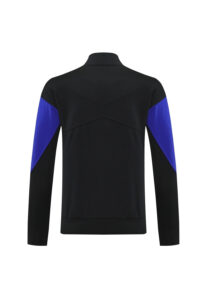 Back view of a black jacket featuring royal blue color-block sleeves.