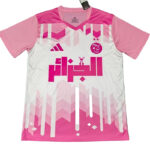 Pink and white soccer jersey with geometric pink pattern and Arabic text logo on the chest.