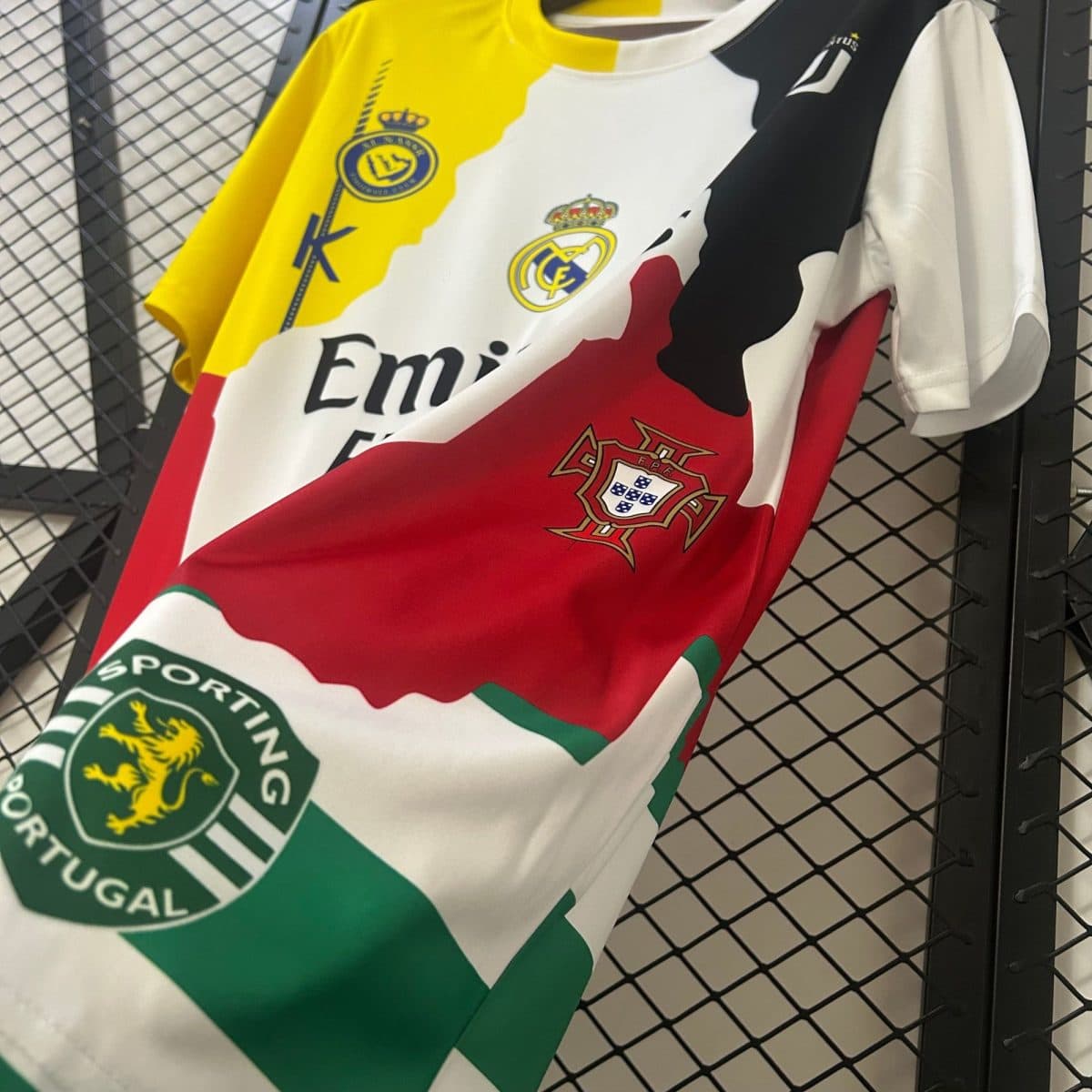 Close-up of stacked football jerseys with Real Madrid crest and Portugal Football Federation badge in yellow, white, and red.