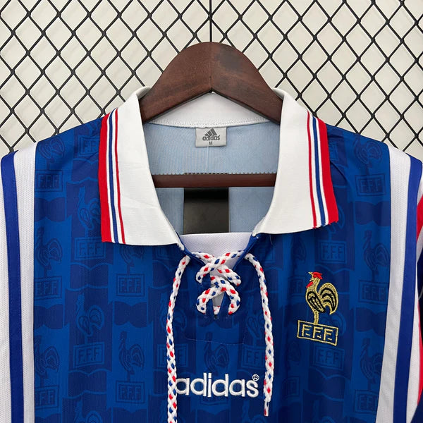 87477e29 | UAE SPORT STORE Blue Adidas football jersey on a hanger, white collar with red/blue trim, lace-up front, crest with a rooster and FFF letters on the chest, Adidas logo below.