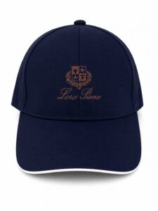 87495232-5f43-4433-bc9c-7d3a95a4ba5d | UAE SPORT STORE Navy baseball cap with brown embroidered crest and 'Loro Piana' script on the front.
