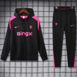 Black athletic hoodie with pink shoulder panels and 'Bingx' logo, paired with black pants with pink accents on a display rack