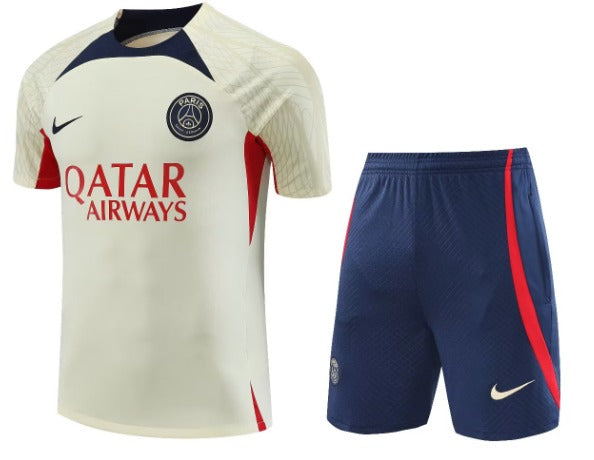 Paris Saint‑Germain soccer jersey and matching shorts: cream jersey with navy and red accents, PSG crest, Qatar Airways sponsor, and navy shorts with a red stripe.