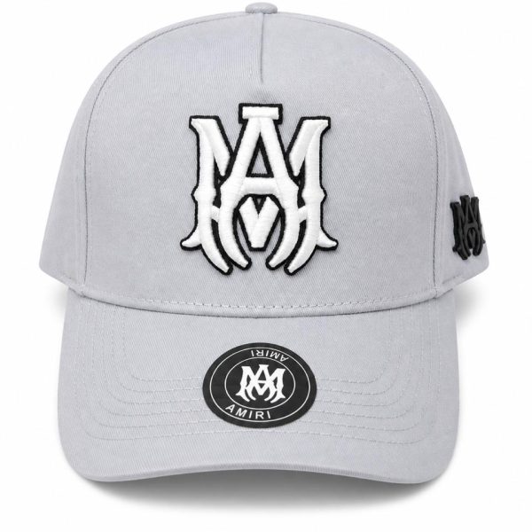 Gray baseball cap with a large white embroidered AM logo on the front and a small side patch; circular sticker on the brim.