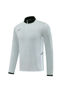 Light gray athletic long-sleeve pullover with black collar and zipper, Nike swoosh on the left chest and white side panel detail on the right side