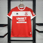 Red and white soccer jersey hanging on a rack, featuring UNIBET sponsor and club crest on the chest.