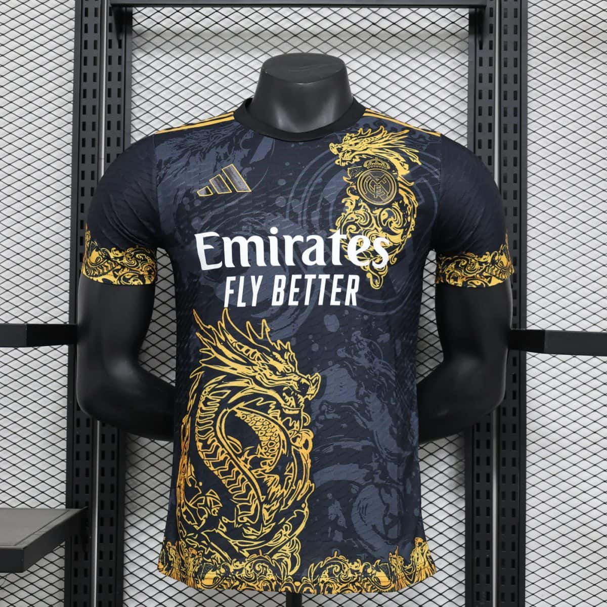 Real Madrid soccer jersey on a mannequin with gold dragon patterns and the Emirates Fly Better sponsor text.