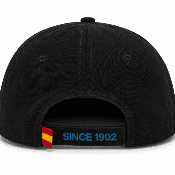 Back view of a black baseball cap with an adjustable strap, featuring blue 'SINCE 1902' embroidery and a small red-yellow flag tab
