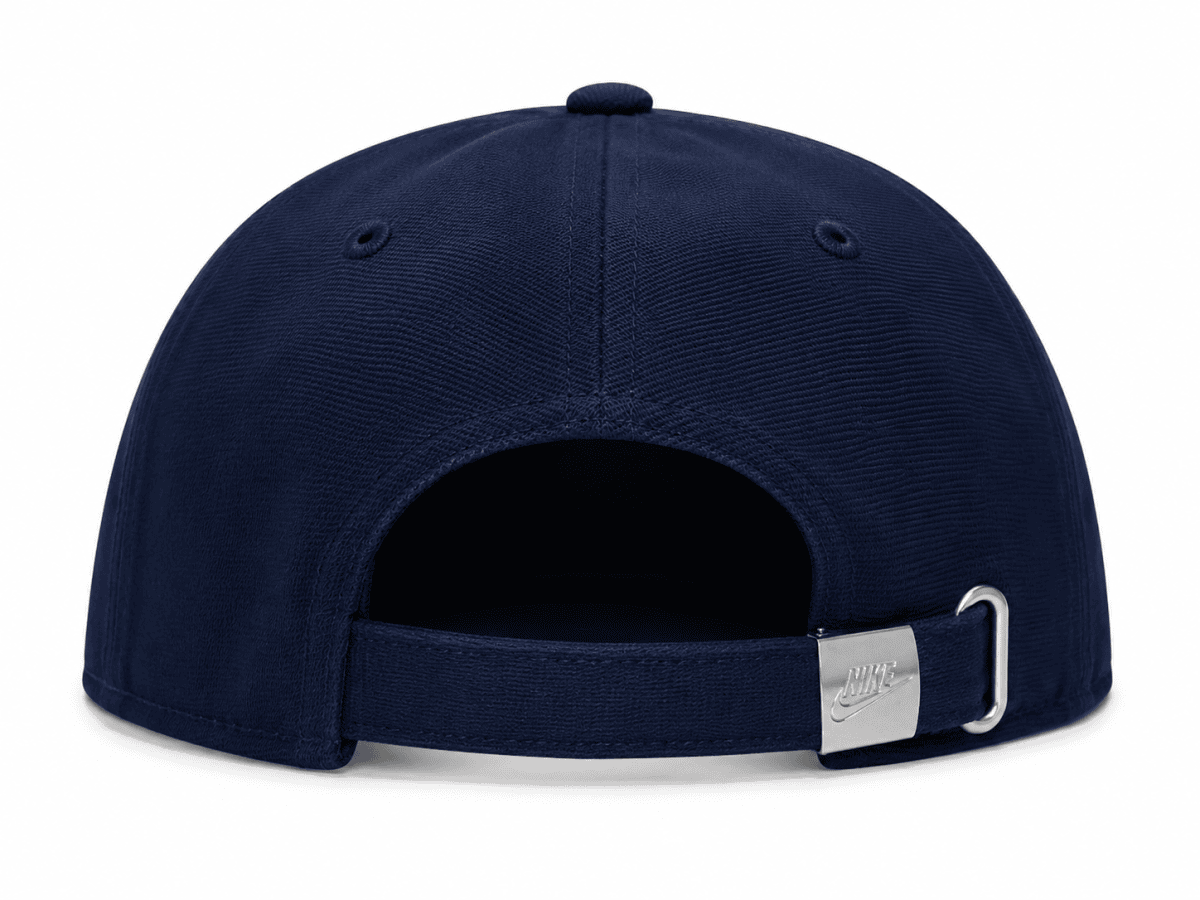 Back view of a navy baseball cap with an adjustable strap and metal buckle, Nike logo on buckle.