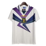 White Umbro soccer jersey on a hanger with bold purple and blue angular chevrons and a crest at the chest.