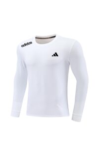 White long-sleeve athletic shirt with black Adidas logos on the left shoulder and chest, round neckline.