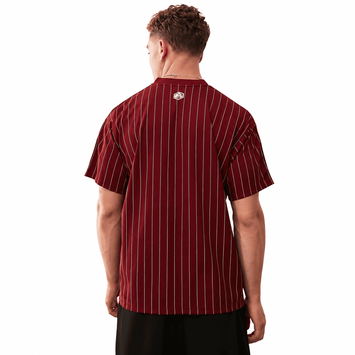 Back view of a man wearing a maroon and yellow striped football jersey.
