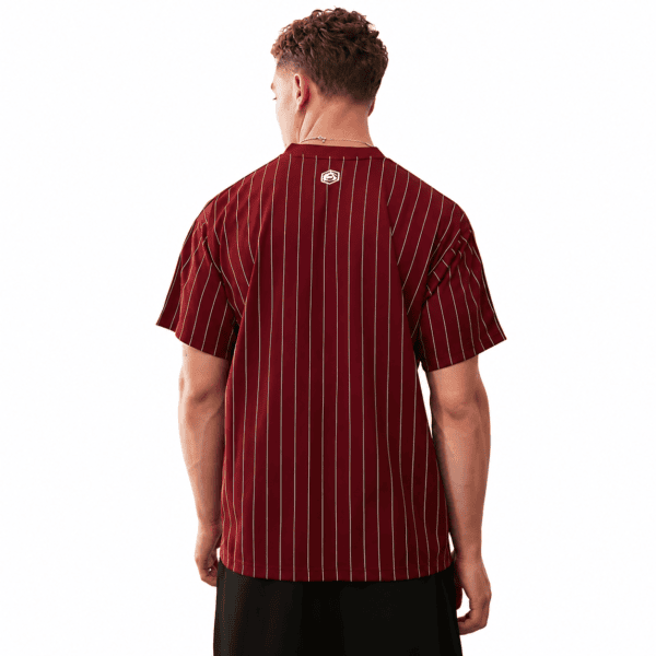 Back view of a man wearing a maroon and yellow striped football jersey.