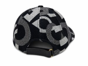 Back view of a black-and-white geometric patterned baseball cap with a leather strap and gold buckle, Gucci branding visible on the strap
