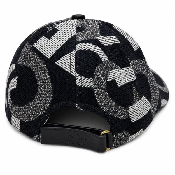 Back view of a black-and-white geometric patterned baseball cap with a leather strap and gold buckle, Gucci branding visible on the strap