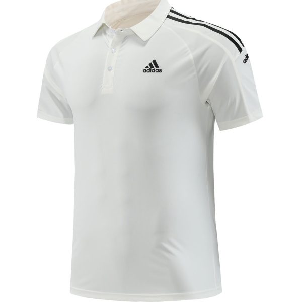 White Adidas polo shirt with black shoulder stripes and embroidered logo on the chest.
