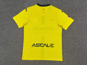 Bright yellow athletic jersey laid flat on a gray carpet, with a dark collar and the 'ASTALE' sponsor logo across the front.