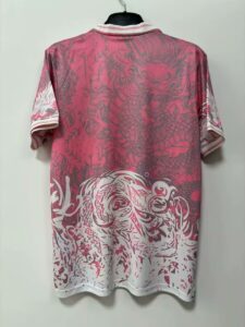 Pink short-sleeve shirt on a hanger with white striped collar; features large gray dragon graphic across the back and a gradient fading to white at the bottom.