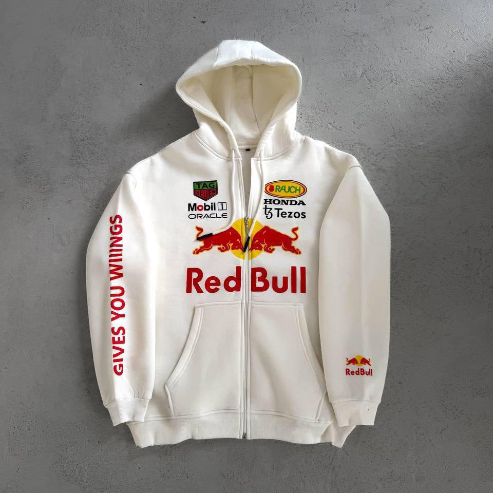 8e255f9e-a567-4ded-867a-42df24a4faaf White zip-up hoodie with Red Bull branding: large Red Bull logo and 'Red Bull' text on the chest, sponsor logos above, and 'GIVES YOU WINGS' along the left sleeve.