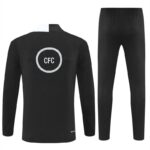 Black tracksuit set with long-sleeve top and slim-fit pants, featuring a white circular CFC logo on the back of the top.