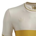White Adidas sports jersey with multicolor striped collar, trefoil logo, and yellow band at the bottom.