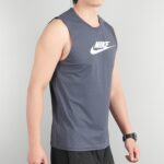Person wearing a gray sleeveless Nike top with a white swoosh logo on the chest beside the shoulder.