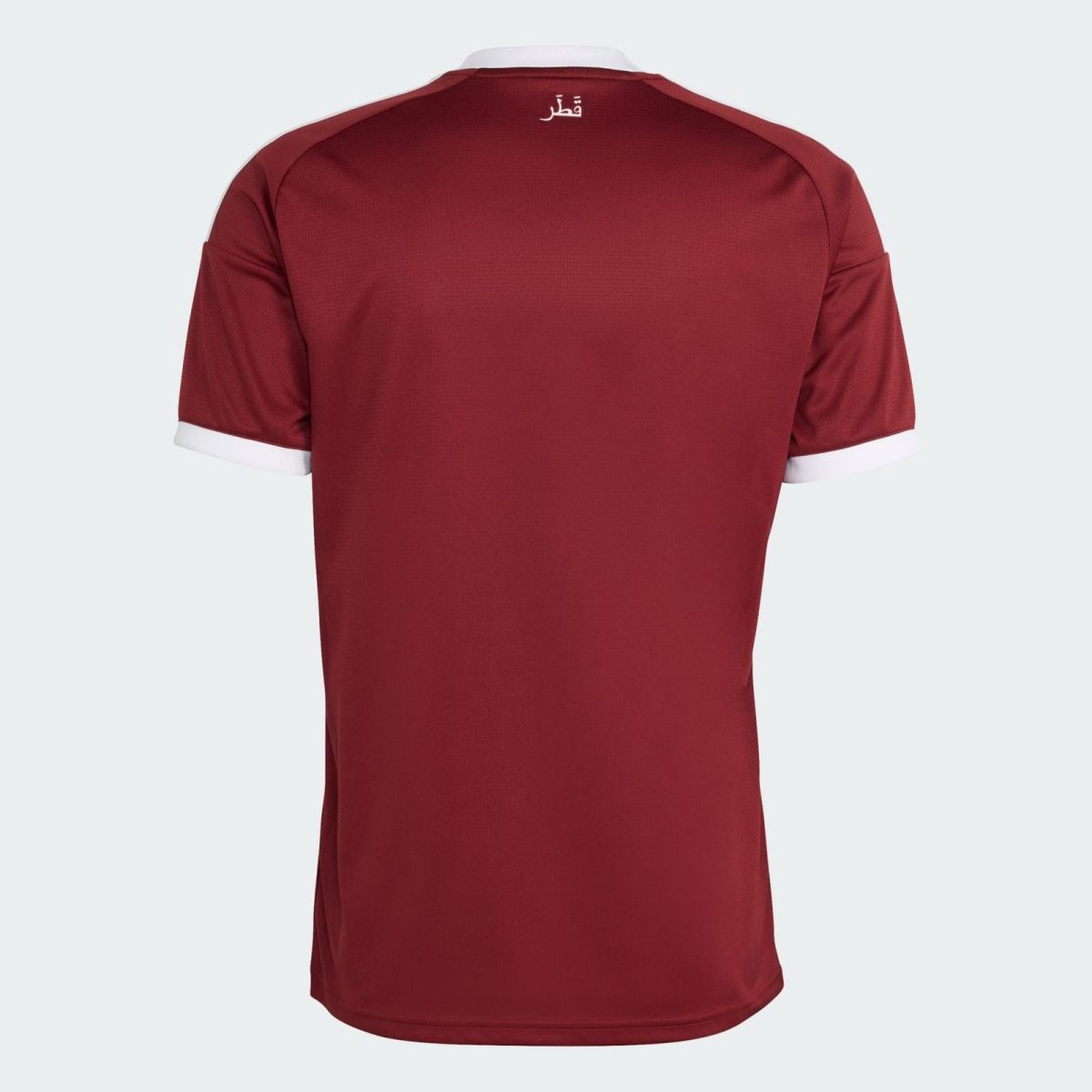 Back view of a maroon polo shirt with white collar trim and a small white Arabic inscription at the neckline.