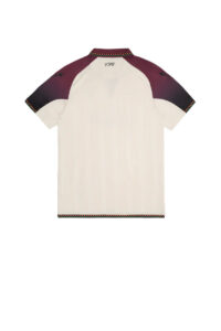 Back view of a cream polo shirt with purple raglan sleeves, multicolor trim at the collar and cuffs, and initials embroidered near the neck.