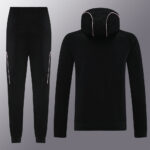 Black athletic tracksuit with pink piping: tapered joggers and a matching hooded sweatshirt, shown from front and back.