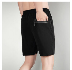 9122c0ef | UAE SPORT STORE Person wearing black athletic shorts with a small zip pocket on the back, hand in pocket.