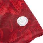 Red marbled fabric sleeve with a small white circular badge reading 'We Are Team'.