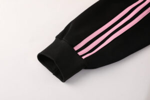 914f4ac3 | UAE SPORT STORE Black athletic pant sleeve cuff with pink triple stripes and ribbed edge.