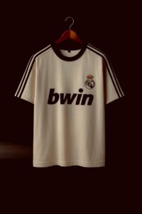 Real Madrid football jersey on a wooden hanger with the bwin sponsor and club crest visible against a dark background