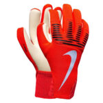 Red goalkeeper gloves with white palm, black grip lines, and a white Nike swoosh.