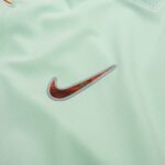 Mint green athletic fabric with a red and silver Nike swoosh emblem.