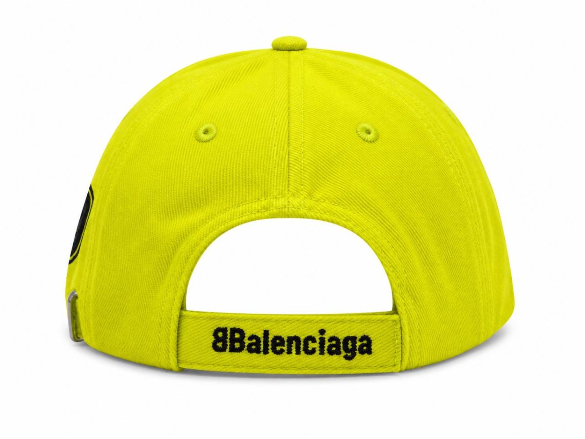 Back view of a neon yellow Balenciaga baseball cap with an adjustable strap and brand name on the strap
