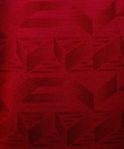 Red textured fabric background with a subtle geometric pattern