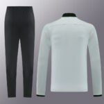 Back view of a light gray athletic jacket with black collar and cuffs, paired with black jogger pants on a gray background.