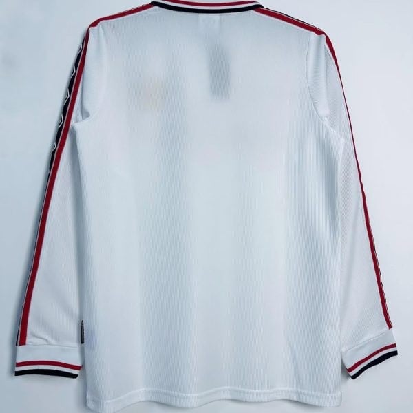 Rear view of the white long-sleeve shirt with red and black shoulder trim and a plain back.