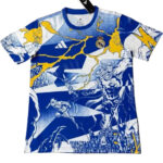 Blue and white Real Madrid soccer jersey with yellow comic-book style graphics and crest visible on chest, action figures design throughout