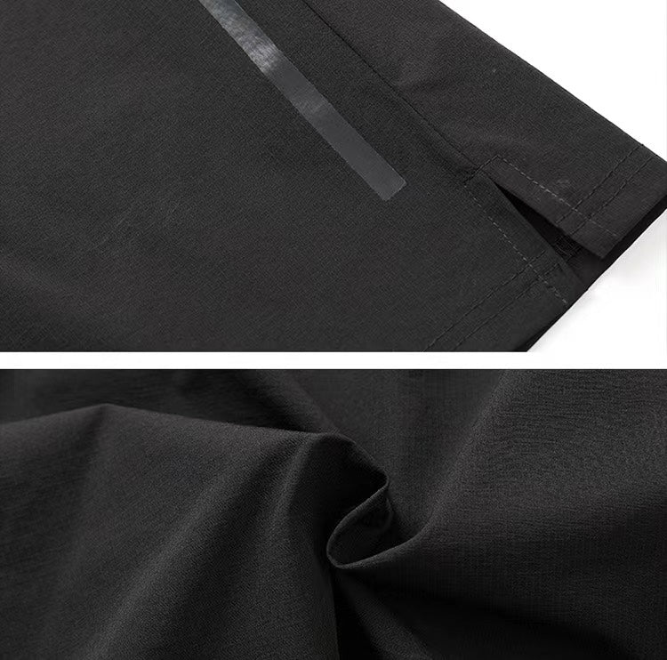 94ef25e6 | UAE SPORT STORE Close-up of black fabric showing a stitched hem and a subtle seam detail, suggesting a garment like pants or shorts (informative).