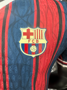 9506d406_2231a59e-05ab-440b-a851-012924da7809 | UAE SPORT STORE FC Barcelona crest on a blue and red striped jersey fabric (FCB badge).